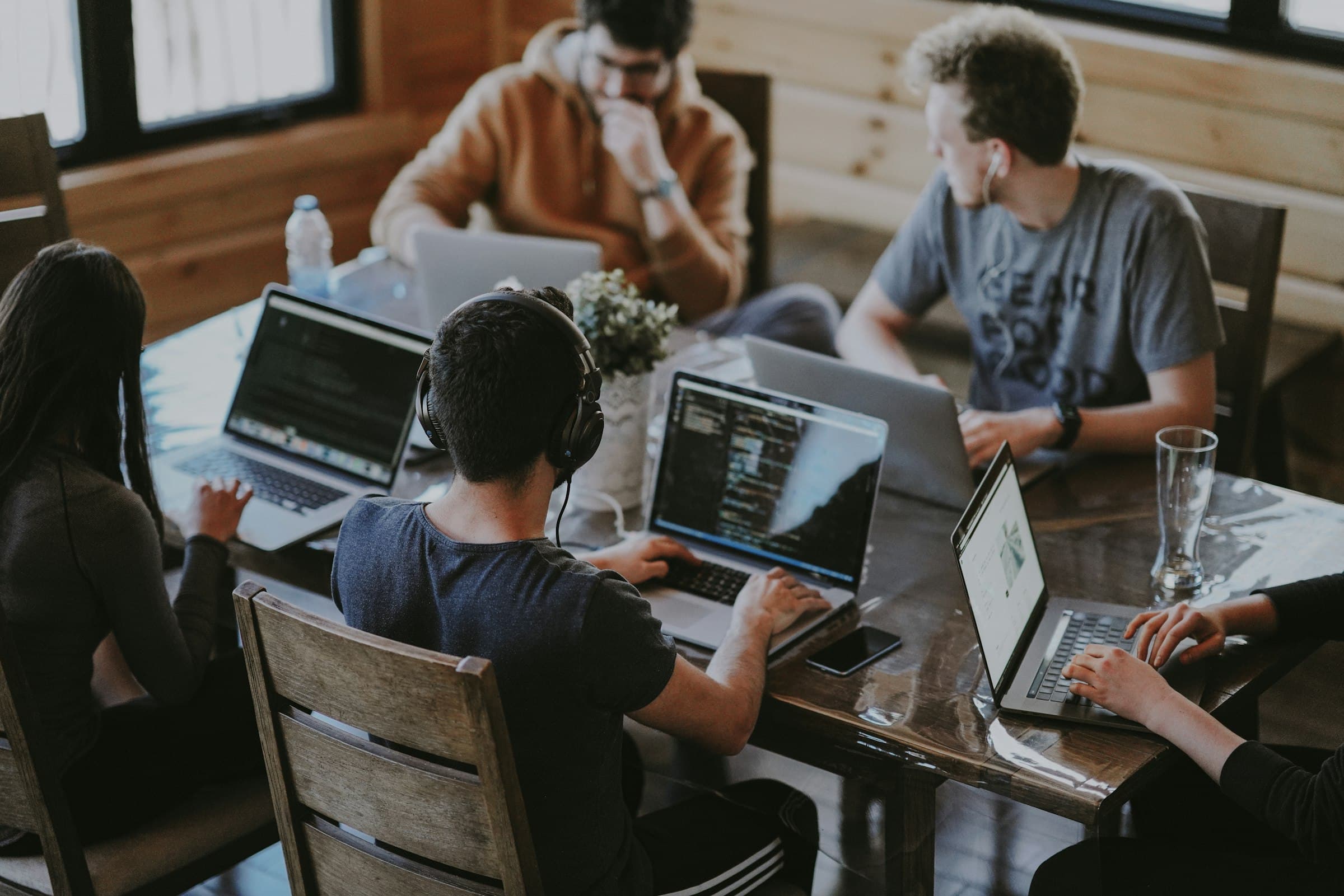 A team working together on laptops around one table