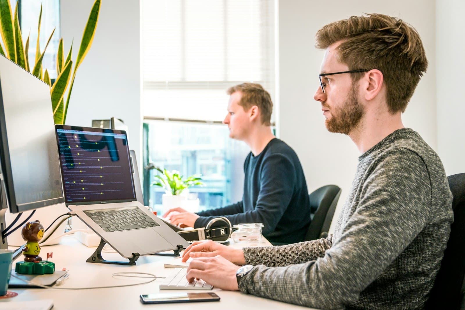Two engineers building software at their desks